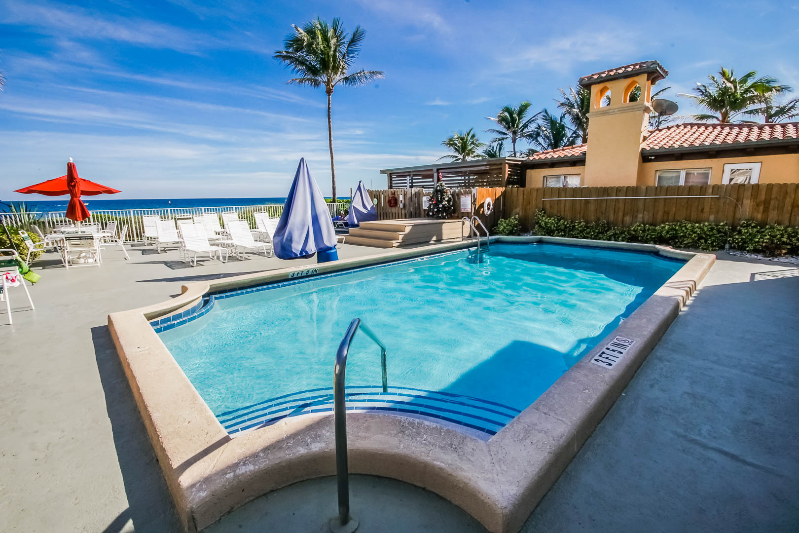 A refreshing pool with an ocean view at VRI's Berkshire Beach Club in Florida